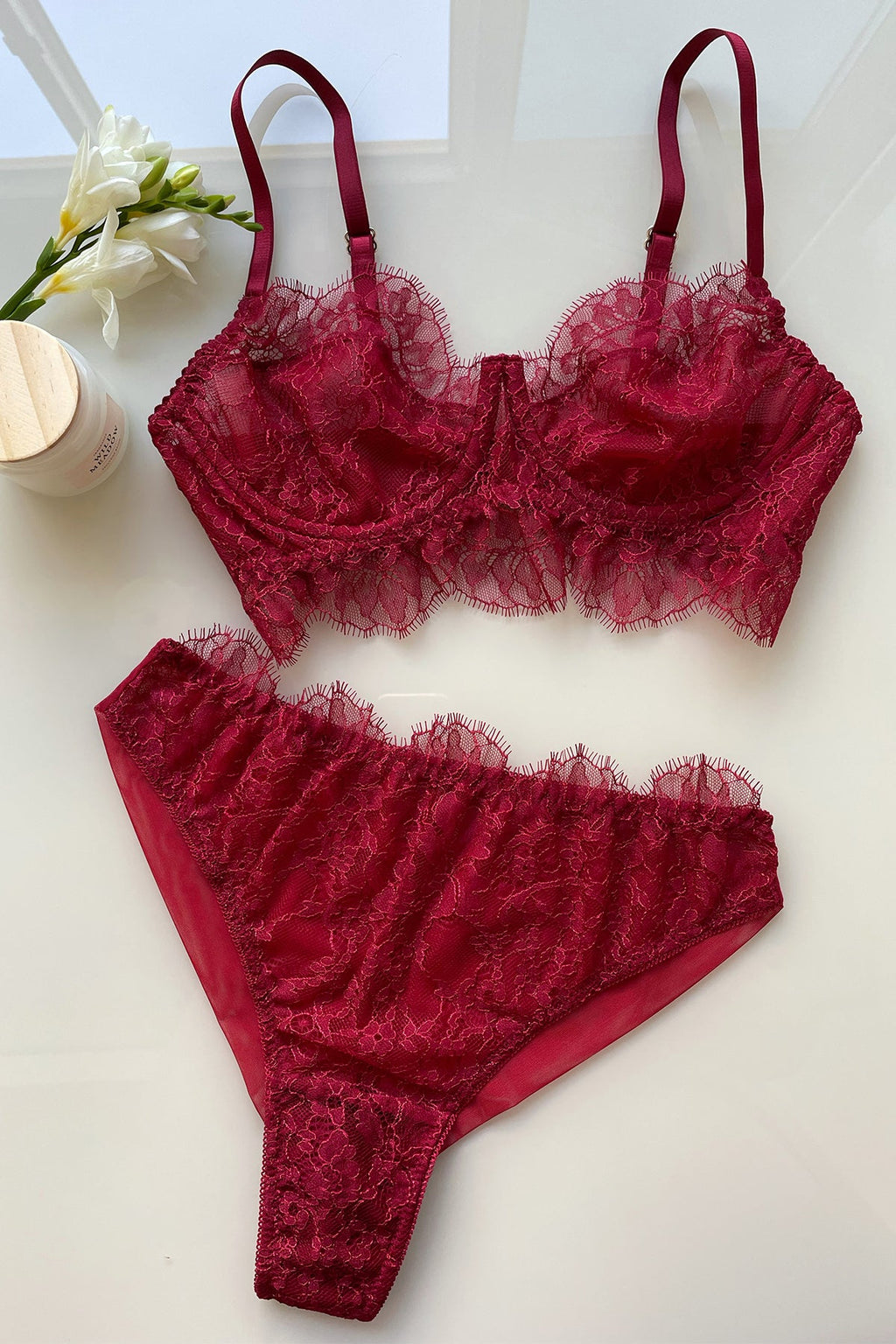 Burgundy lace bra in female hand. Fashion concept Stock Photo by